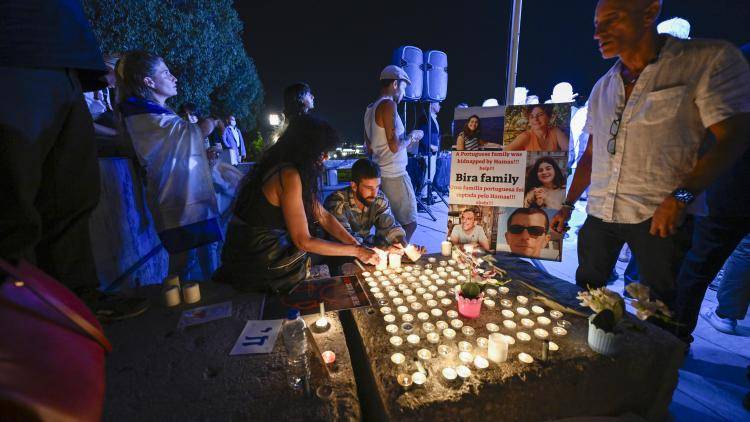 Participants light candles during a vigil organized by the Lisbon Jewish Community for Israeli victims of the Hamas attack on October 10, 2023, in Lisbon, Portugal.