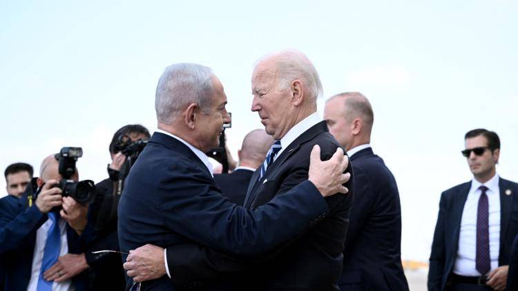 Israeli Prime Minister Benjamin Netanyahu greets US President Joe Biden upon his arrival at Tel Aviv's Ben Gurion airport on October 18, 2023