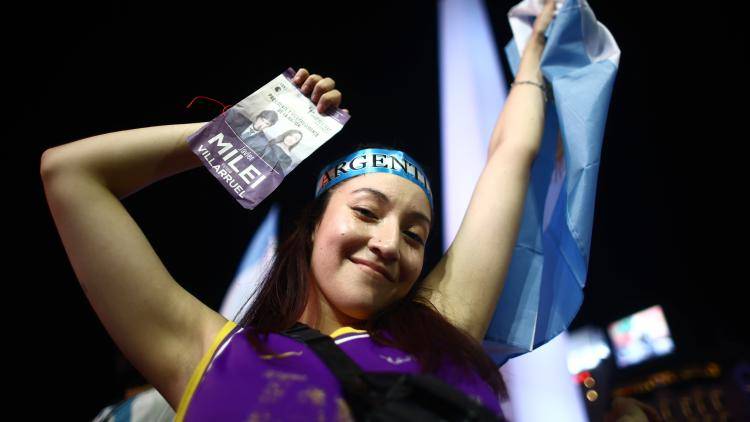 A supporter of newly elected President of Argentina Javier Milei of La Libertad Avanza celebrates after the polls closed in the presidential runoff