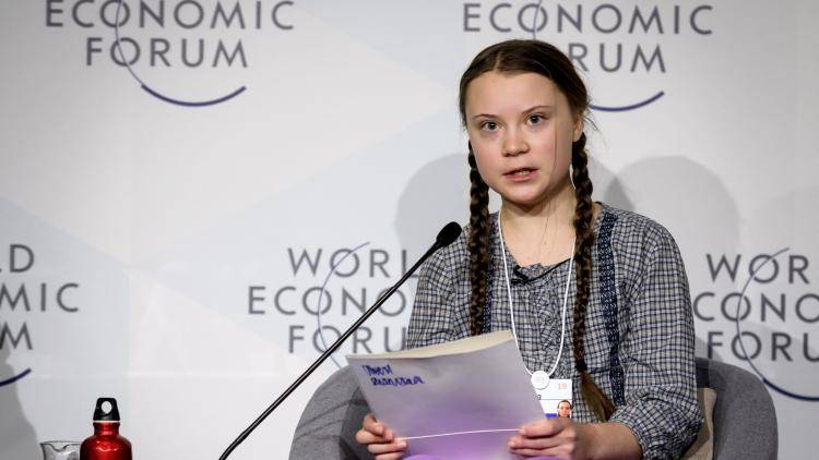 Greta Thunberg speaks from a chair at the 2019 World Economic Forum in Davos