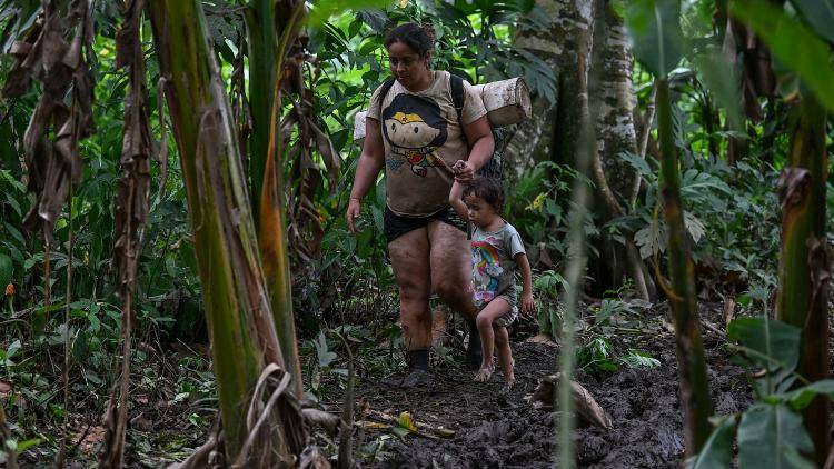 A woman and young child in thick jungle of the Darien Gap in Panama