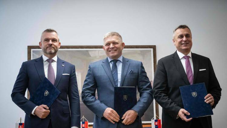 Prime Minister of Slovakia Robert Fico stands flanked by leader of the Hlas party Peter Pellegrini and leader of the SNS party Andrej Janko in October 2023, having formed a coalition government
