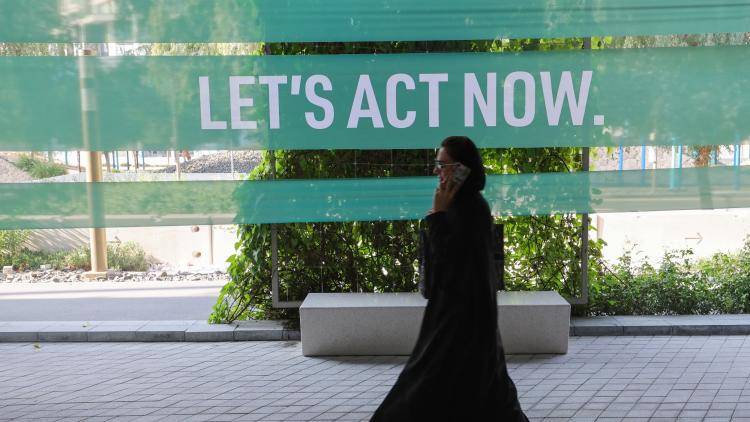A delegate walks outside during the United Nations' COP28 climate talks at Expo City in Dubai on December 12, 2023.