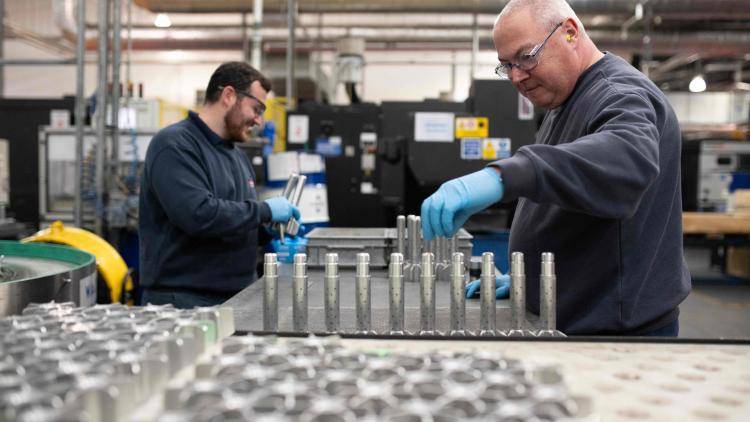 Employees work on high explosive mortar munitions at the BAE Systems factory near Newcastle upon Tyne, England in November 2023