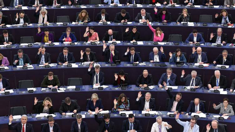 Members of the European Parliament take part in a voting session during a plenary session at the European Parliament in Strasbourg, on 13 March 2024. 
