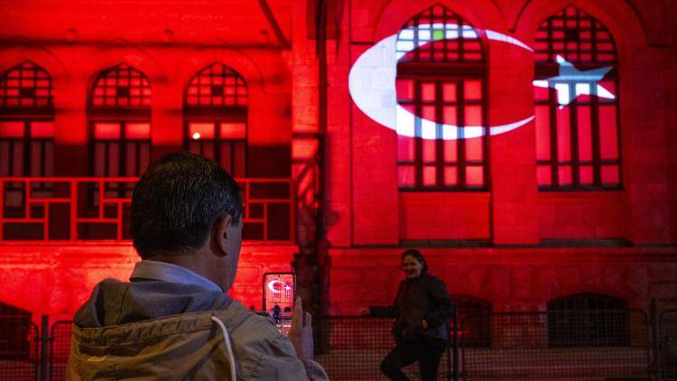 The First Parliament Building illuminated with the colours of the Turkish flag.