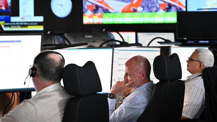 Members of staff work on computers in the maintenance control room inside Easyjet's new operations Integrated Control Centre (ICC) in Luton, north of London on 22 May 2024.