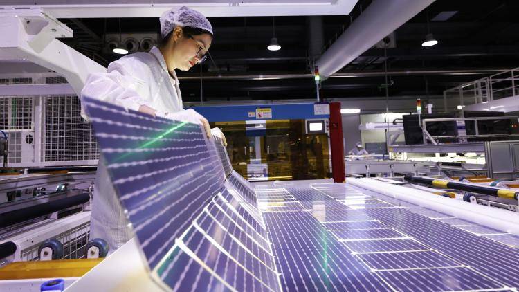 An employee works on the production line of export-bound solar panels in China.