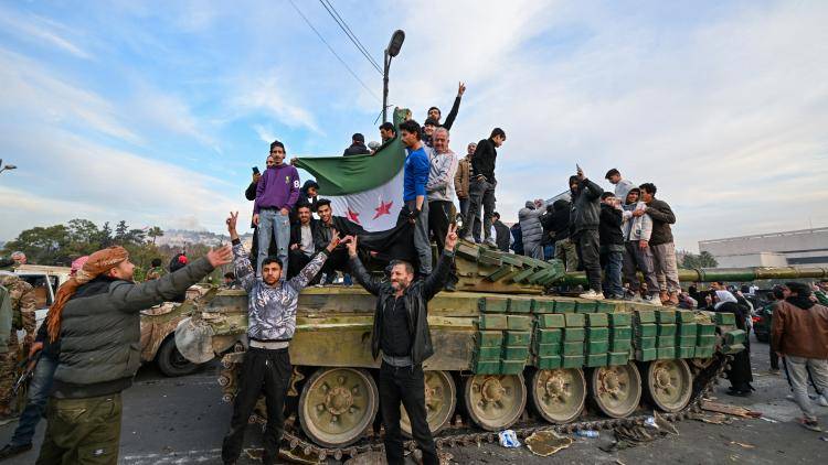 People celebrate with anti-government fighters at Umayyad Square in Damascus on 8 December 2024.