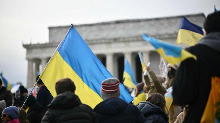 People holding Ukrainian flags demonstrate in support of Ukraine.