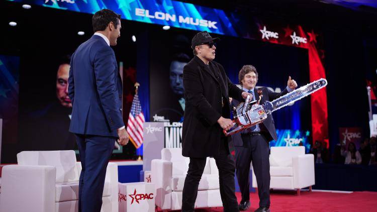 Elon Musk brandishes a chainsaw on stage with Javier Milei