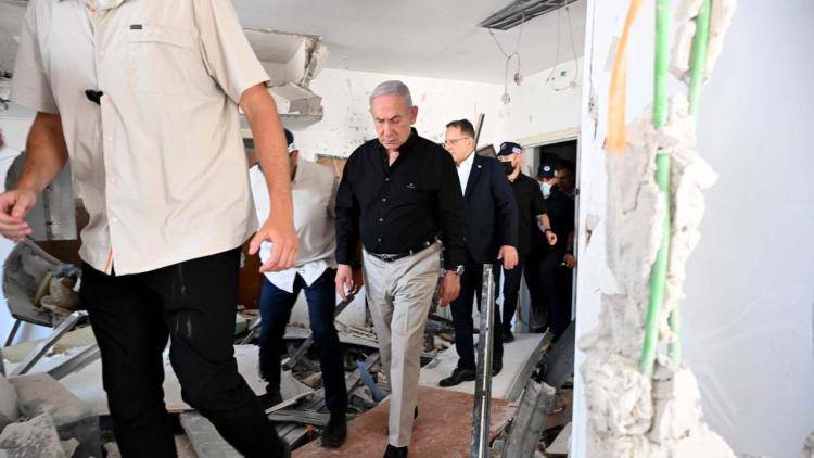 Israeli Prime Minister Benjamin Netanyahu inspects demolished apartment buildings following an Iranian ballistic missile attack