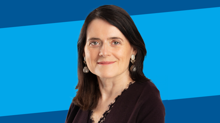 Headshot of Bronwen Maddox on blue background.