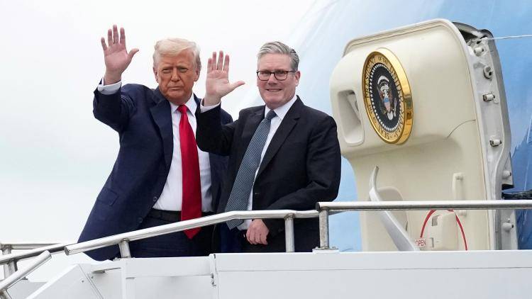 President Donald Trump and Prime Minister Keir Starmer wave as they board Air Force One on 28 July 2025 in Prestwick, Scotland. (Photo by Andrew Harnik/Getty Images)