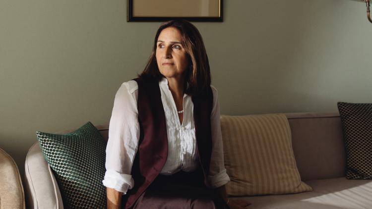 Marina Wheeler sits on a sofa looking sideways