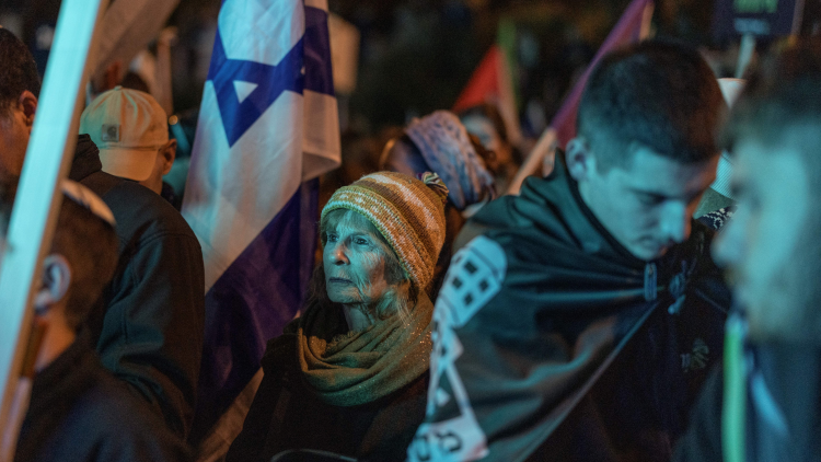 A woman holds an Israeli flag during a protest in Jerusalem on 15 January 2026.