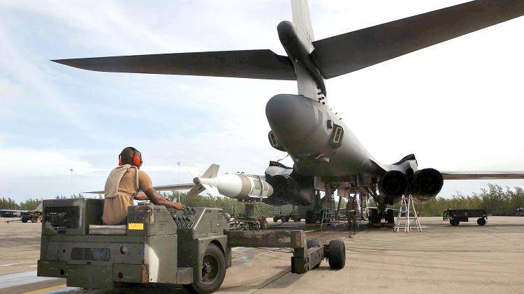 A US Air Force weapons loader loads a 2,000lbs bomb onto a B1 bomber 22 October 2001 at the Diego Garcia base.