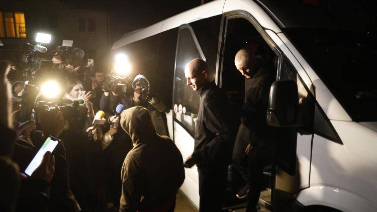a political prisoner climbs out of a vehicle to meet reporters