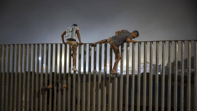 Men scale the border fence between Ceuta and Morocco on 31 July, 2026.