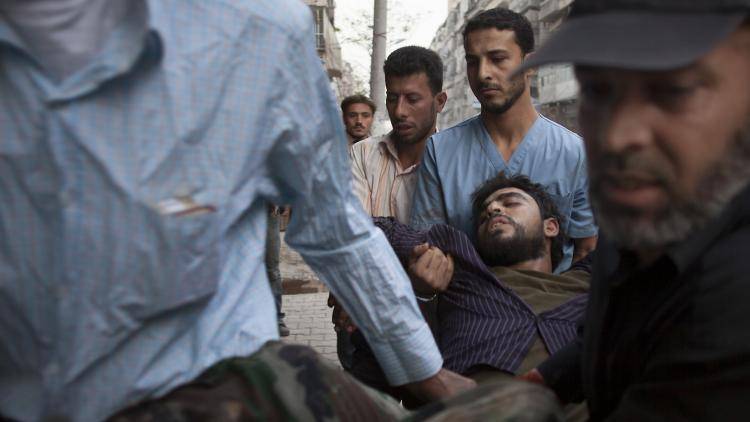 A wounded Syrian rebel is rushed to a clinic after being shot by a regime sniper in the northern city of Aleppo. Photo: Fabio Bucciarelli/AFP/Getty Images