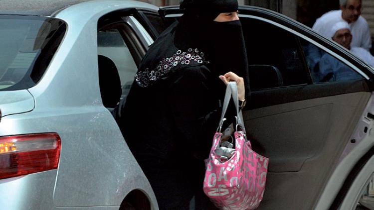 A Saudi woman gets out of the back seat. Photo: Fayez Nureldine/AFP/Getty Images