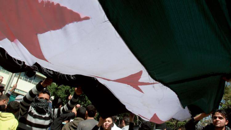 Anti-regime protesters display Syria's pre-Baath flag. Photo: Anwar Amro/AFP/Getty Images