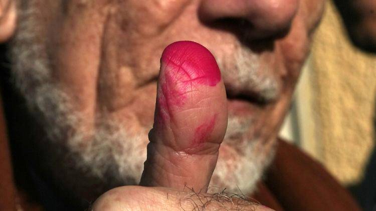 An Egyption shows his ink-stained thumb after casting his vote in the 2011 elections. Photo: Mahmud Hams/AFP/Getty