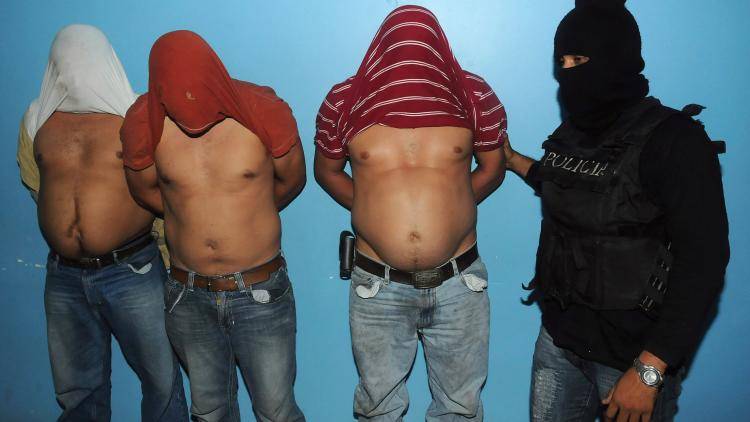 Cocaine buyers are placed under arrest in Honduras. Photo: STR/AFP/Getty Images