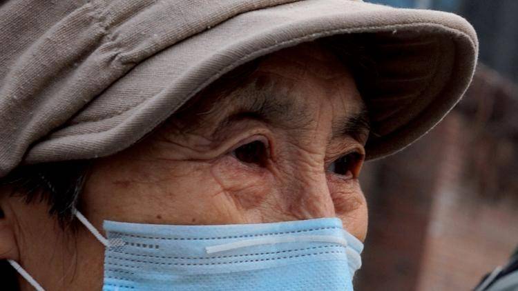 An elderly woman wears a mask as protection against air pollution in Beijing. Photo: Mark Ralston/AFP/Getty Images