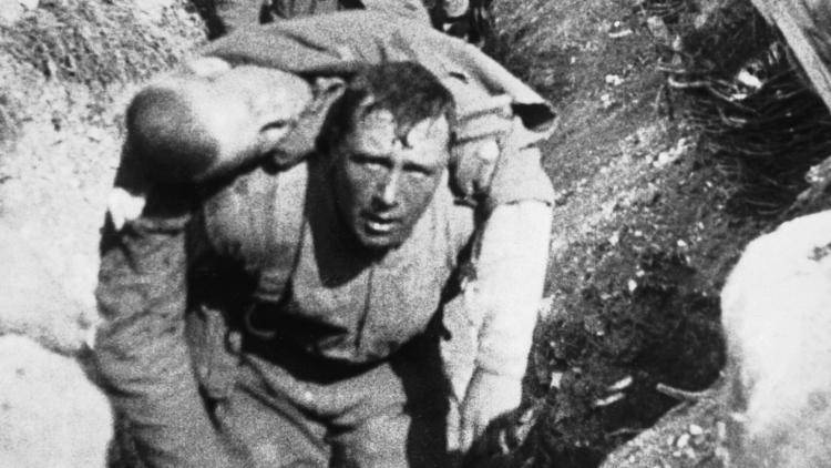 An injured soldier is carried by a comrade on the first day of the battle of the Somme. Photo: IWM via Getty Images