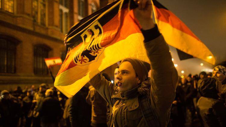 A Pegida member marches through Berlin protesting at the Islamization of Germany Photo: Getty Images
