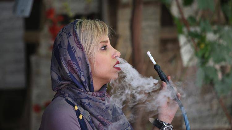 A woman smokes a hookah in Shiraz. Photo: John Moore/Getty Images