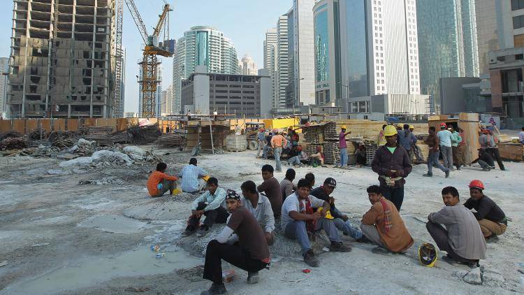 Bangladeshi building workers take a break on a city centre construction site in Doha. Photo: Sean Gallup/Getty