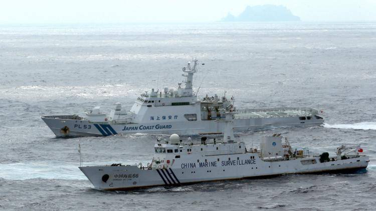 A Japanese coastguard ship and a Chinese surveillance vessel keep watch on each other by the disputed Senkaku islands. Photo: The Asahi Shimbun via Getty Images 