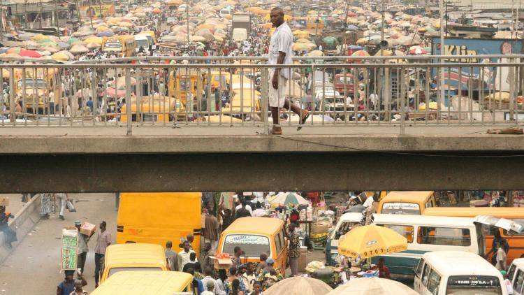 The daily bustle in one of the many busy markets in Lagos, yet the proportion of the Nigerian population still living on a dollar a day is 63 per cent. Photo: UIG via Getty Images