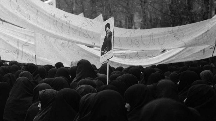 Female protesters wave a poster of Ayatollah Khomeini in Tehran in 1979 