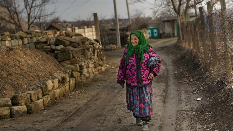 A woman walks through a village near Chisinau, Moldova