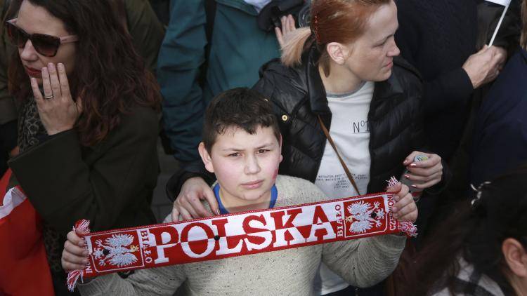 A boy holds up his Polish scarf during the 1 Day Without Us protest in London by EU citizens who fear being used as bargaining chips in the Brexit talks