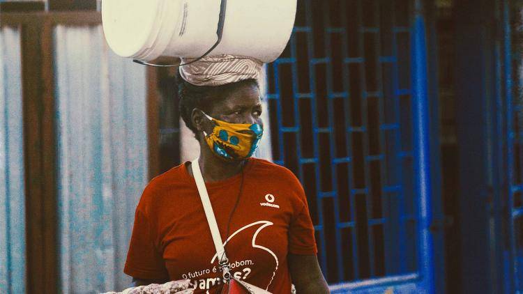 A Mozambican women wears a capulana protective mask