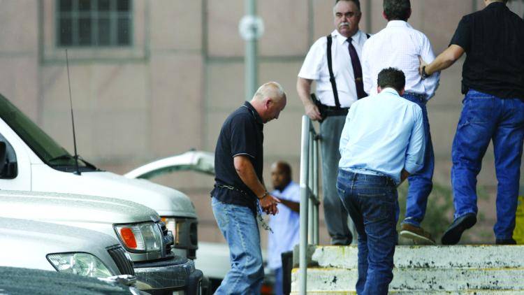 British bankers Giles Darby, Gary Mulgrew and David Berminham, from the left, former employees of NatWest, enter a Houston court in July
