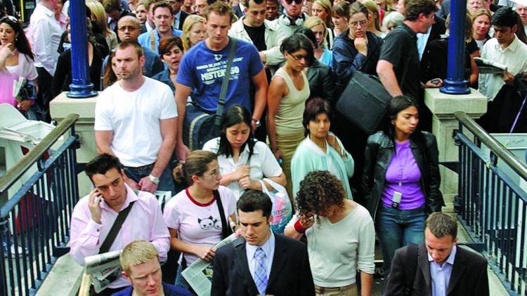 Commuters crowd the entrance to London's Oxford Circus underground station.