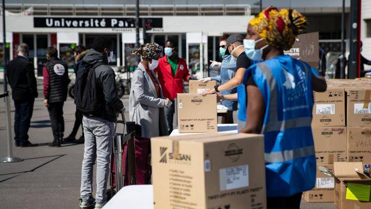 A French charity distributes food and hygiene care products in Saint-Denis, France