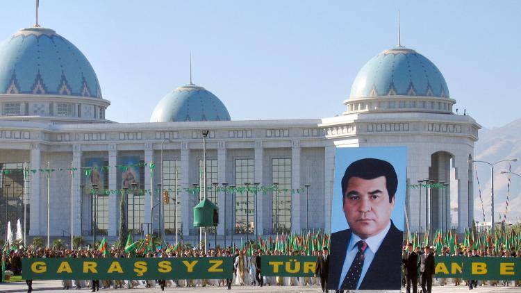 Participants of a parade carry a portrait of Saparmurat Niyazov as they celebrate the Turkmenistan's Independence Day