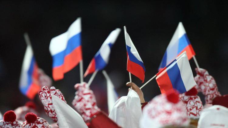 The Russian delegation waves flags during the opening ceremonies of the 2006 Winter Olympics in Turin, Italy