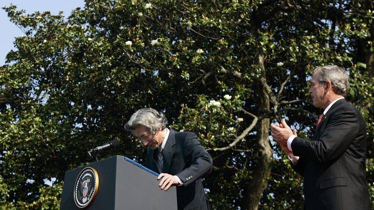 Japanese Prime Minister Junichiro Koizumi(C) bows down