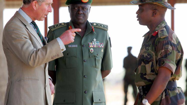 Britain's Prince Charles (L) accompanied by Nigeria's chief of army staff General Martin Luther Agwai (C) and Colonel Ethan