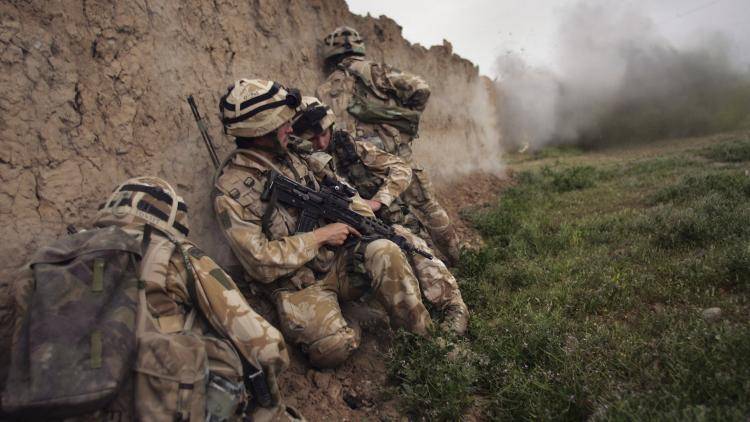 British Marines take cover during an anti-Taliban operation in the Afghan province of Helmand