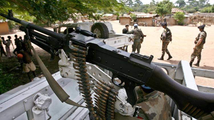 A French Licorne troop soldier stands guard in an armed vehicle in the village of Kongonou 