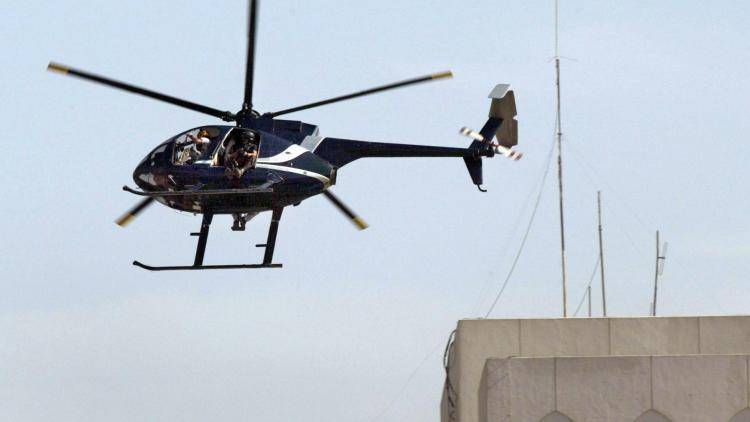 A US private security company Blackwater helicopter flies over Baghdad in 2003