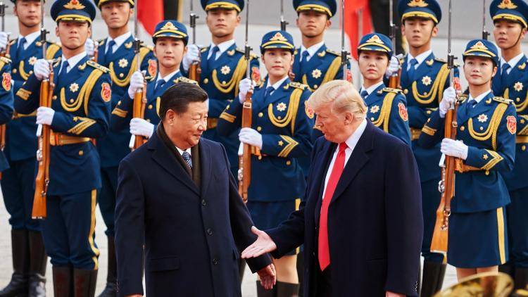 Donald Trump and Xi Jinping shake hands in Beijing, 2017